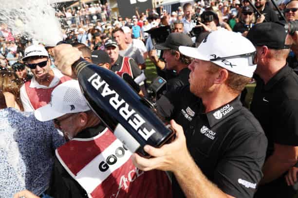 Talor Gooch celebrating his win Talor Gooch holding a trophy after winning a golf tournament
