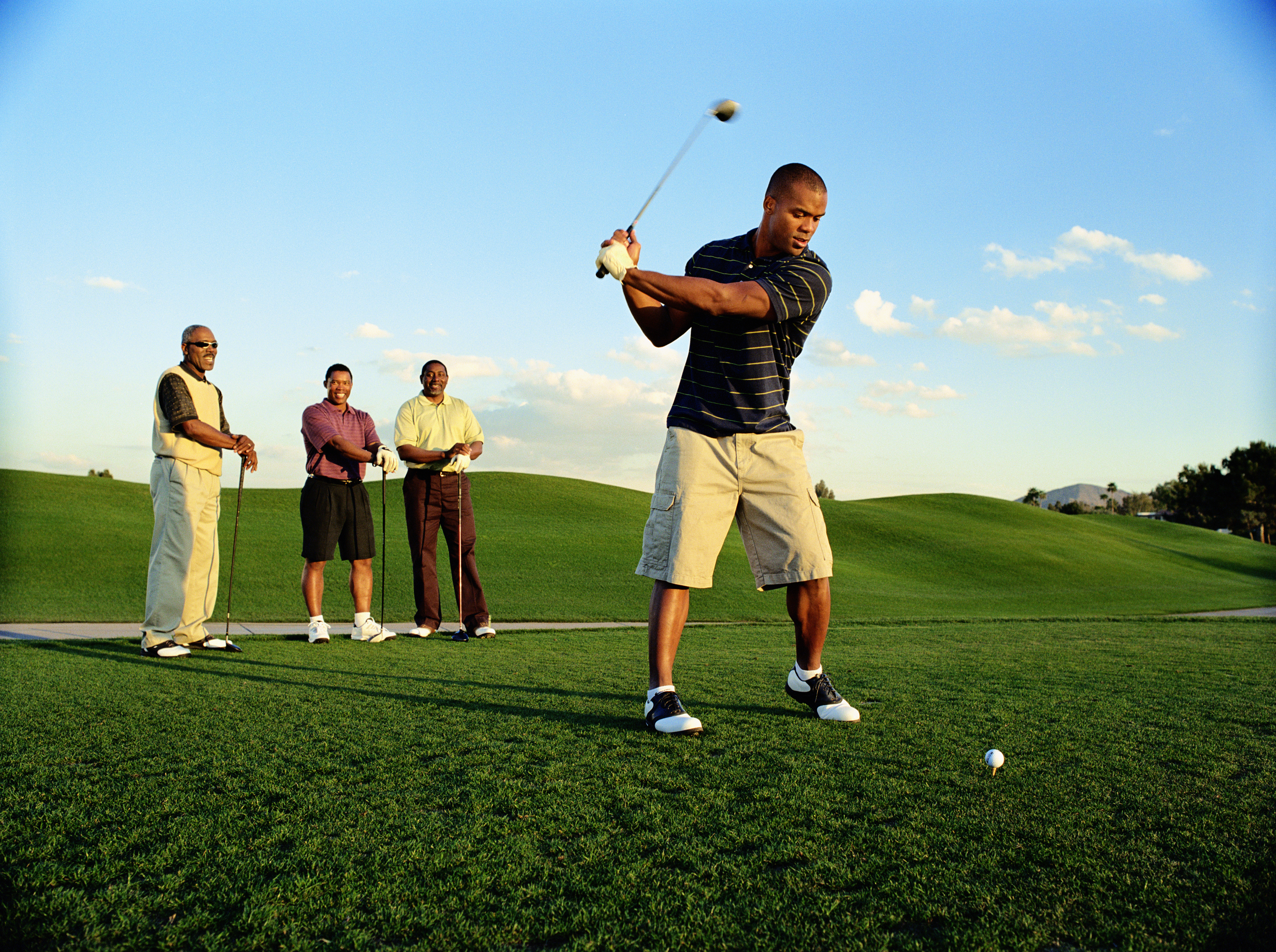 Perfecting Your Golf Backswing A golfer at the top of their backswing, demonstrating proper form