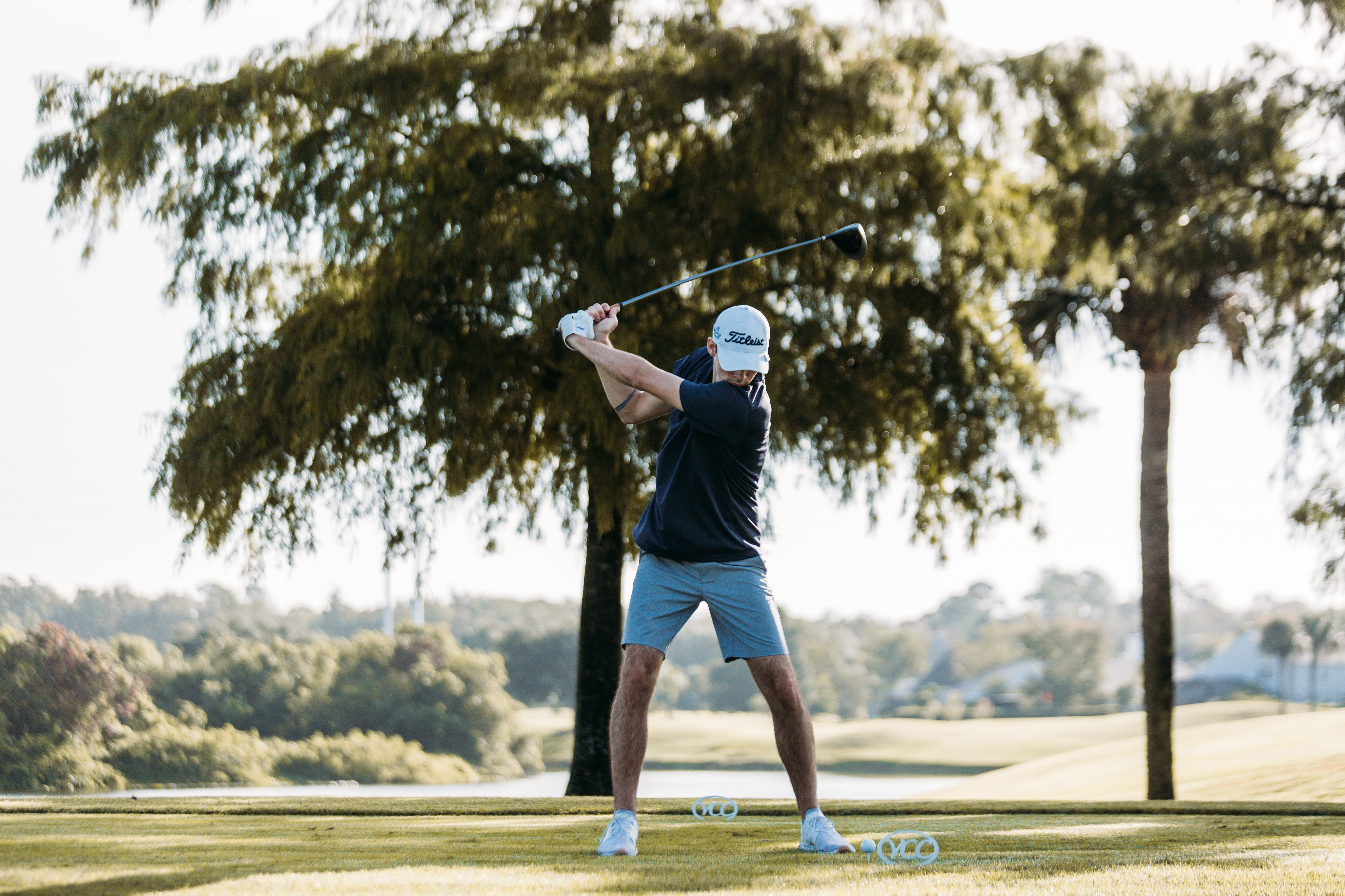 The Benefits of a Shorter Backswing A golfer with a more compact, shorter backswing for improved accuracy