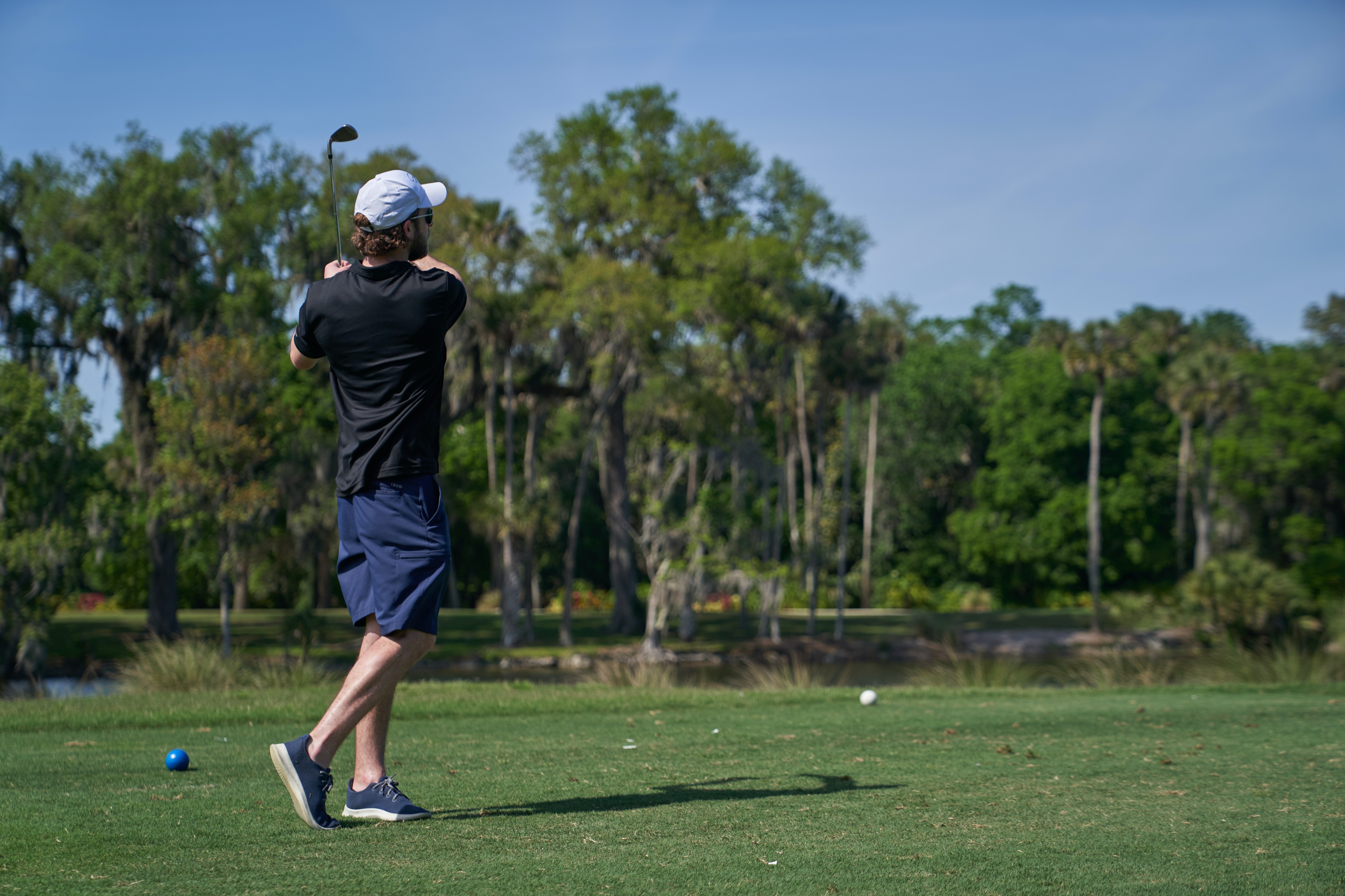 Turn, Don't Sway A golfer at the top of their backswing, illustrating a proper turn instead of a sway